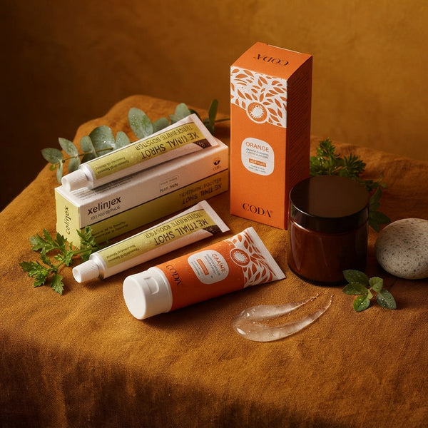 A premium skincare serum bottle placed on a warm cream linen surface with botanical accents to represent skin hydration.